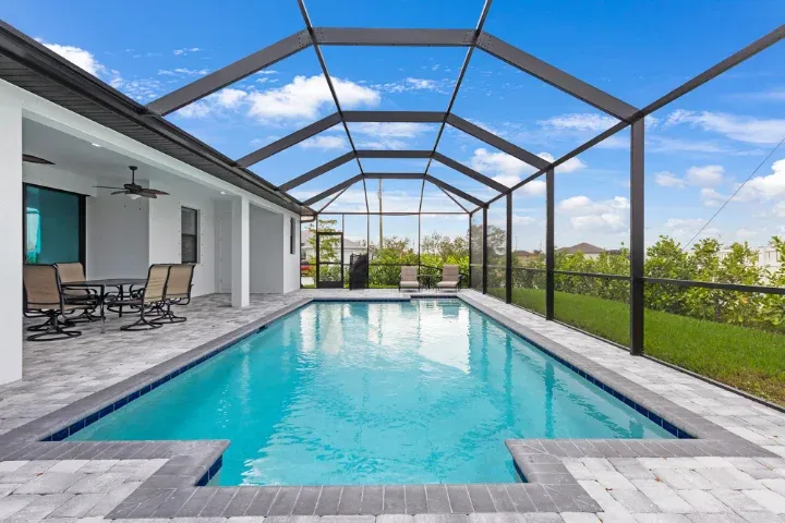 Screened pool enclosure and paver lanai at a Central Florida home
